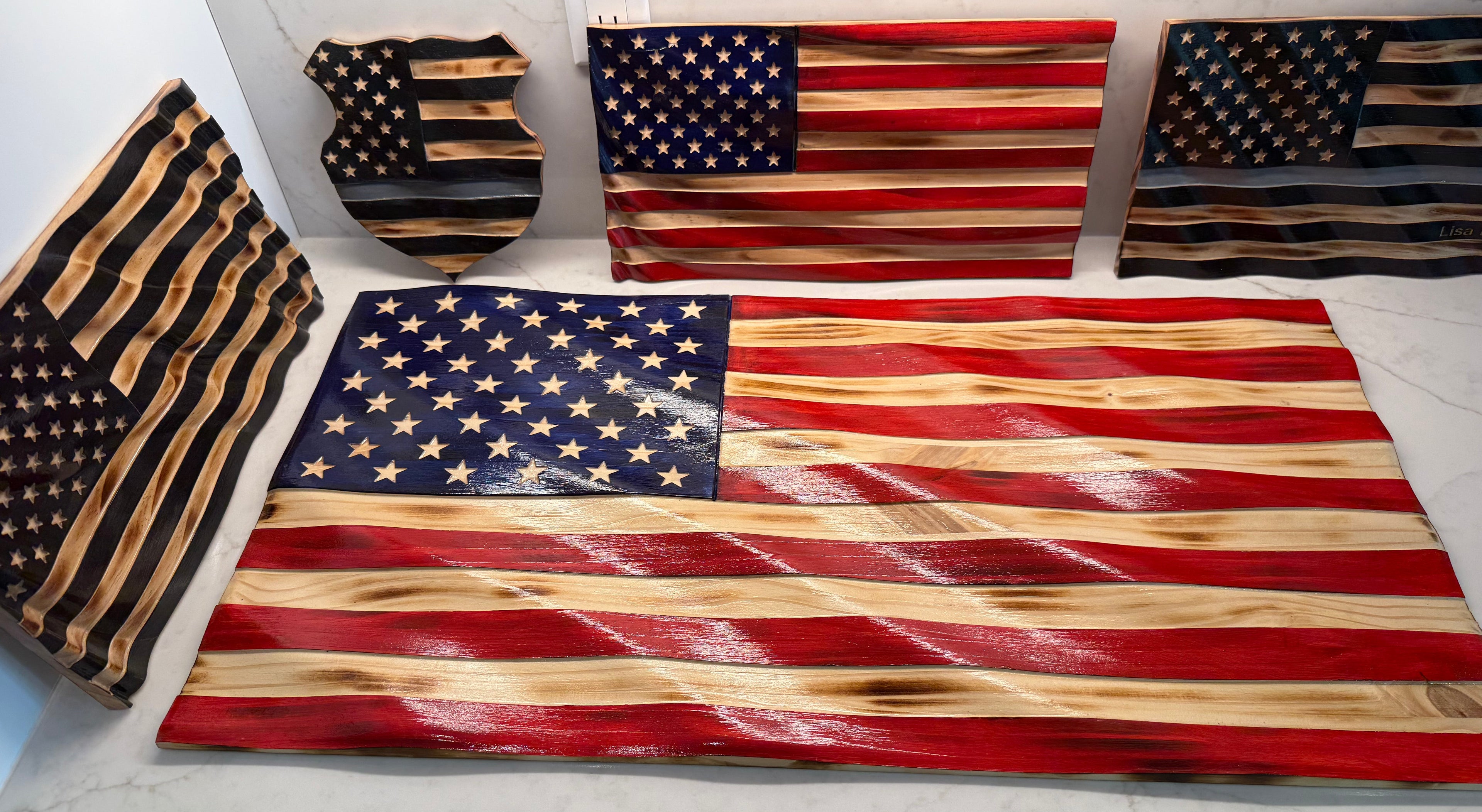 Wooden American flags displayed on a surface with a neutral background
